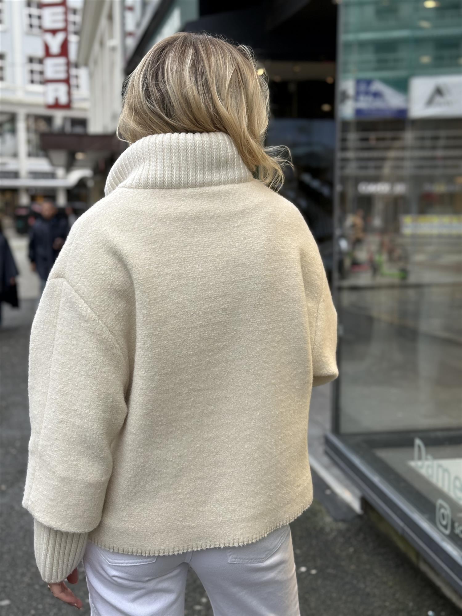 Short oversized white wool coat with knitted details