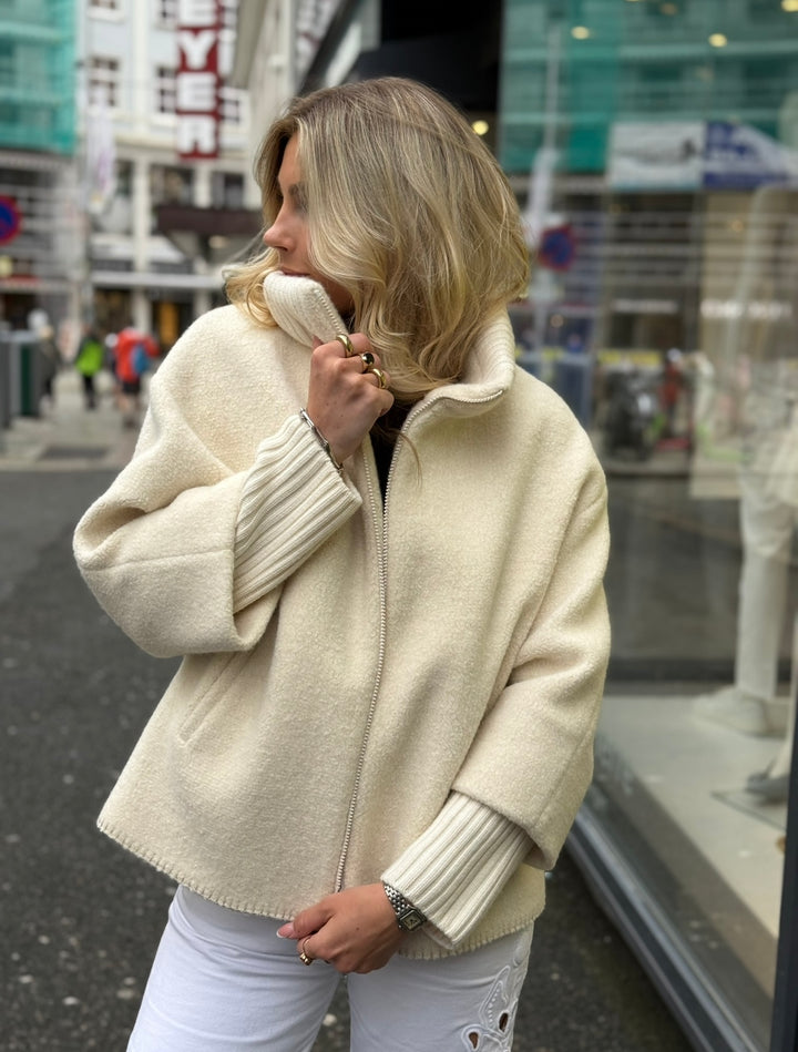 Short oversized white wool coat with knitted details